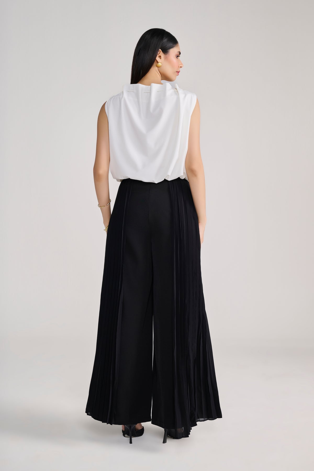 White sleeveless balloon top with tie up detail at neck