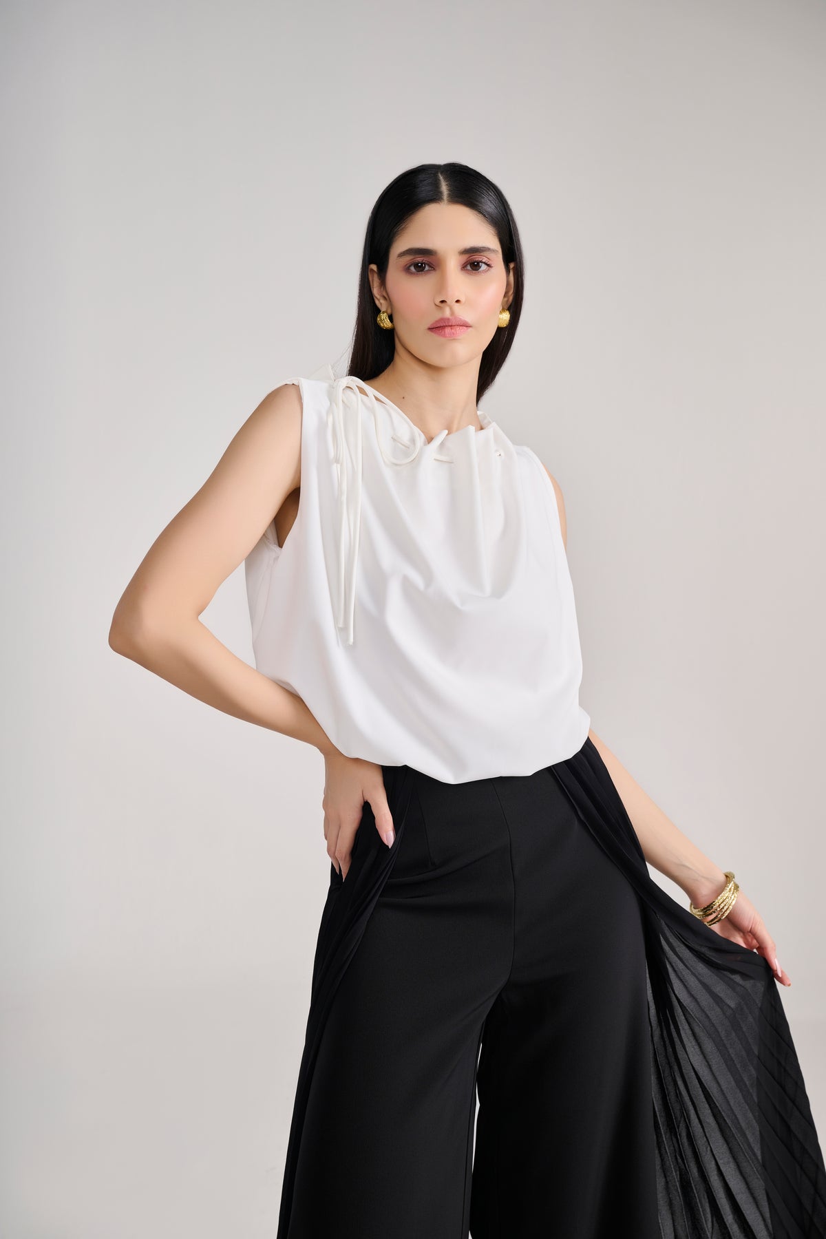 White sleeveless balloon top with tie up detail at neck