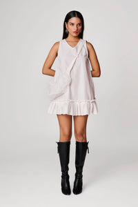 Short white dress with pleated detail at hem and sling bag