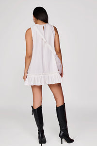 Short white dress with pleated detail at hem and sling bag